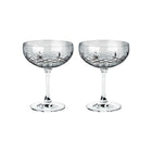 To facetslebne champagneskåle i røget krystalglas med diamantmønster og klar stilk fra Frederik Bagger