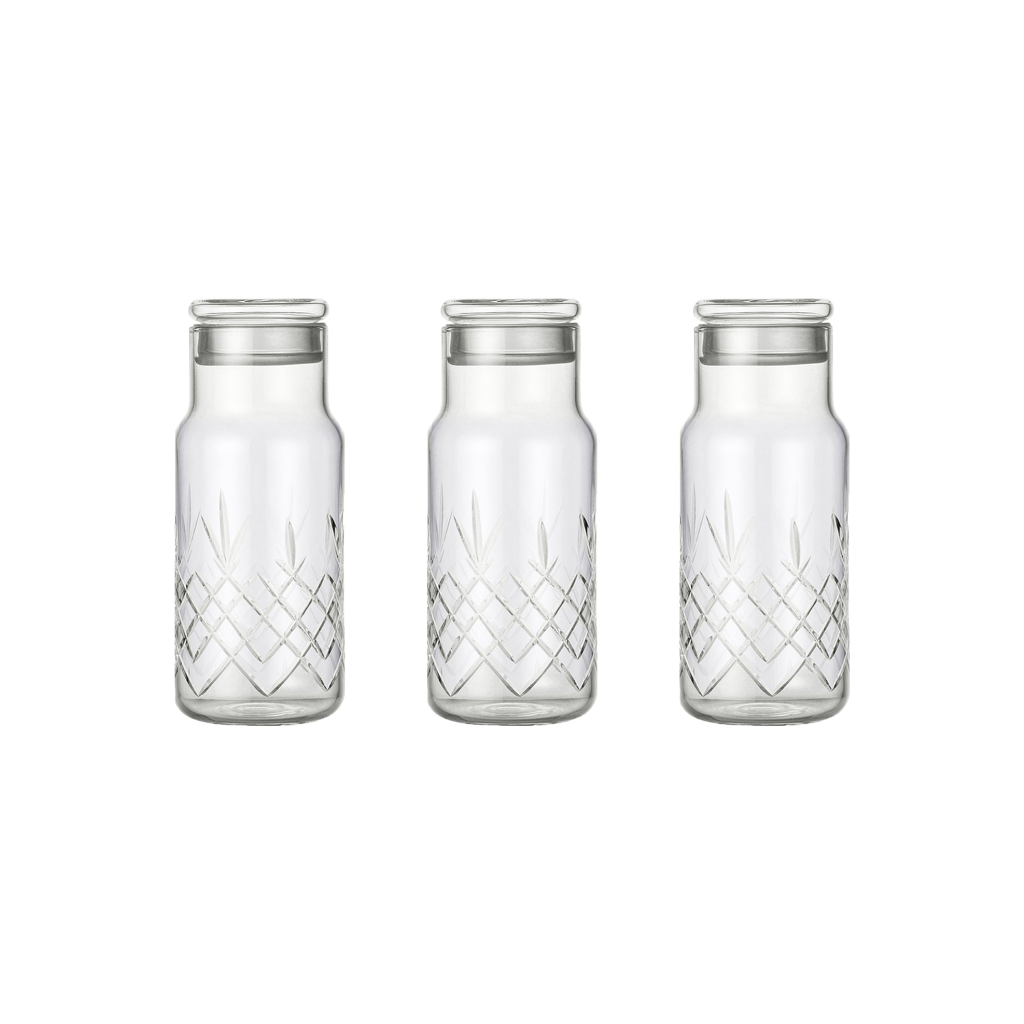 Tre klare facetslebne glasflasker med diamantmønster og låg til opbevaring fra Frederik Bagger
